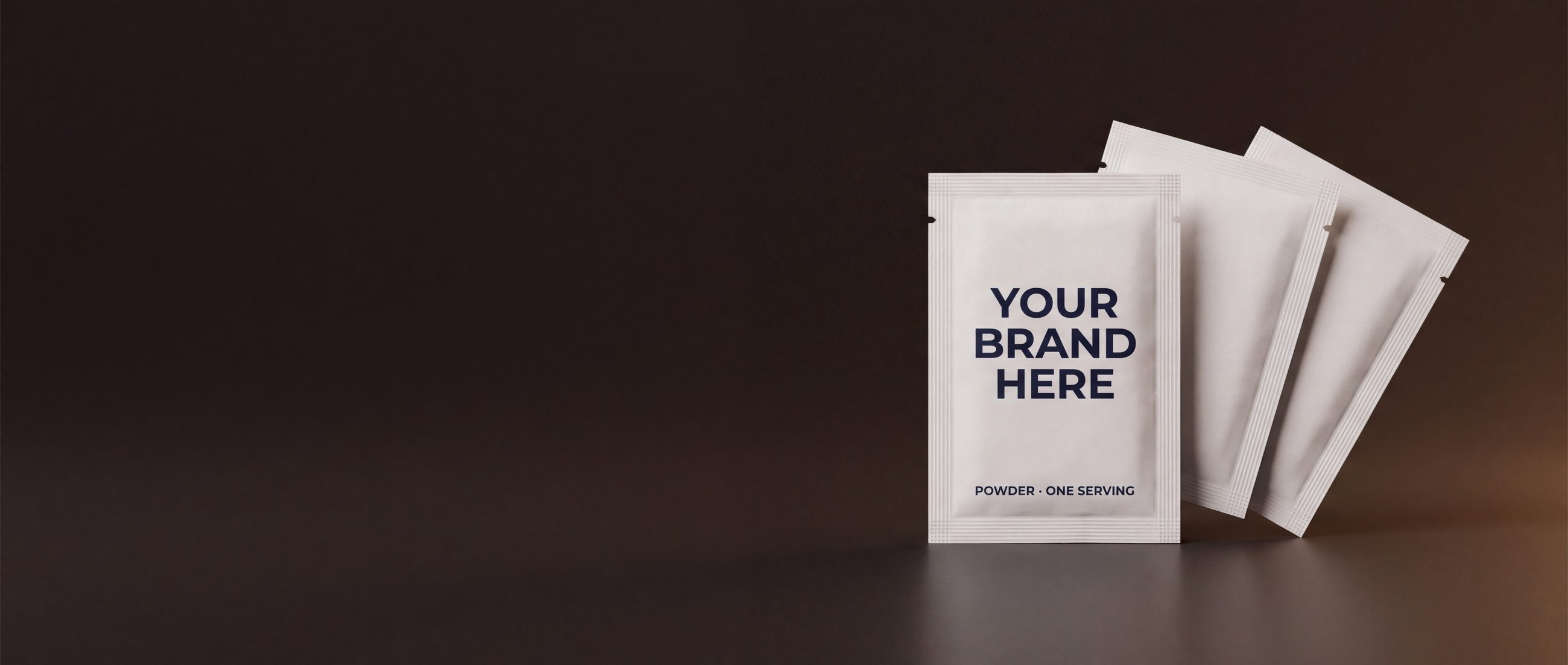 Blank powder sachets with YOUR BRAND HERE printed on the front — private label mockup